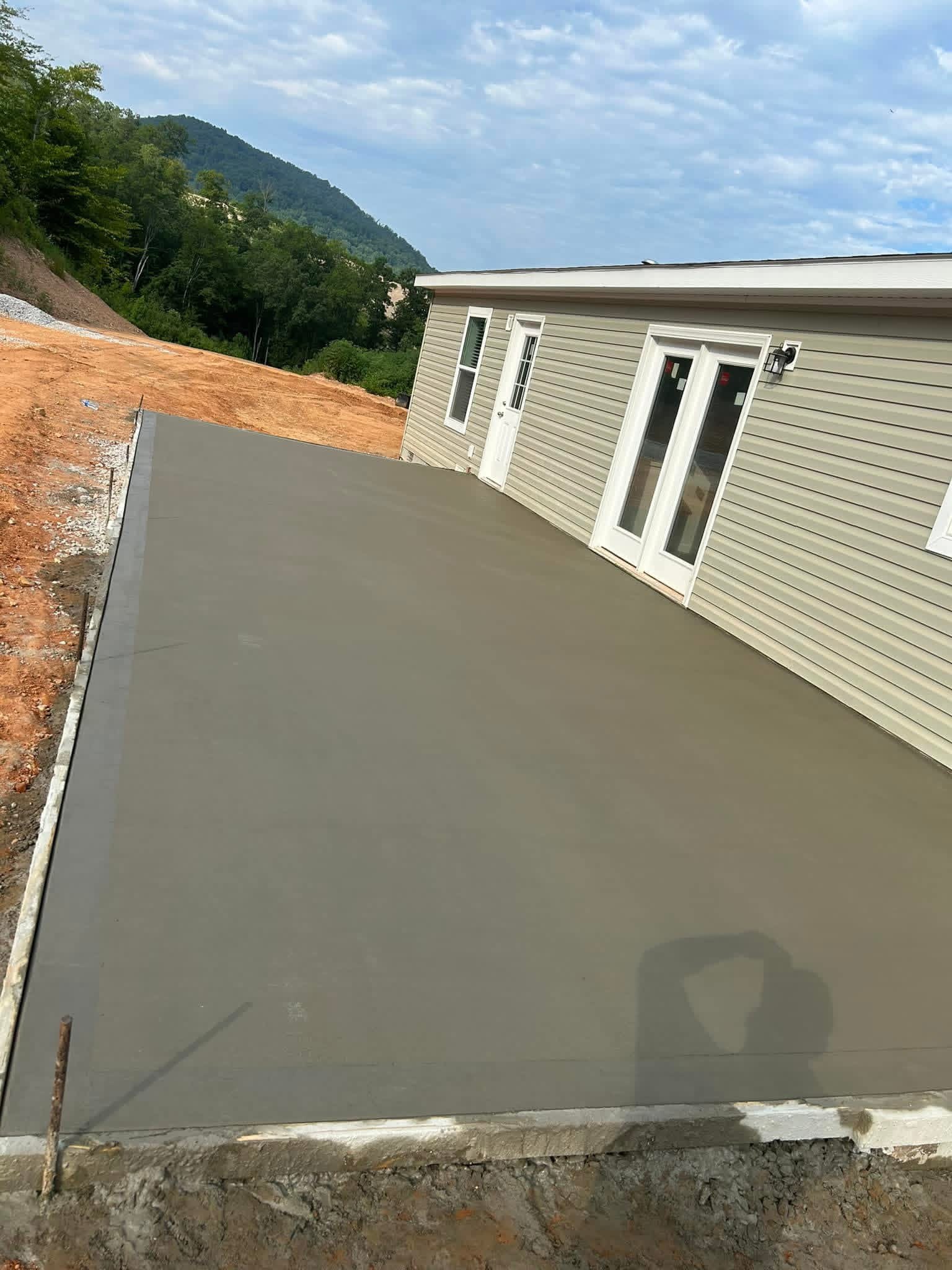 Large finished concrete slab beside a home
