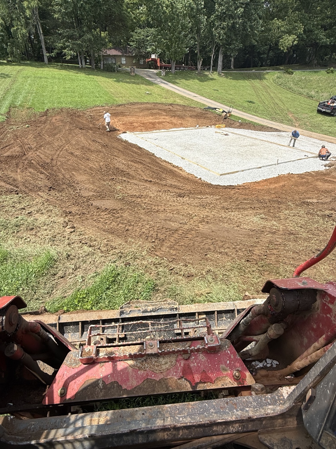 Graded and compacted building pad prepared with stone