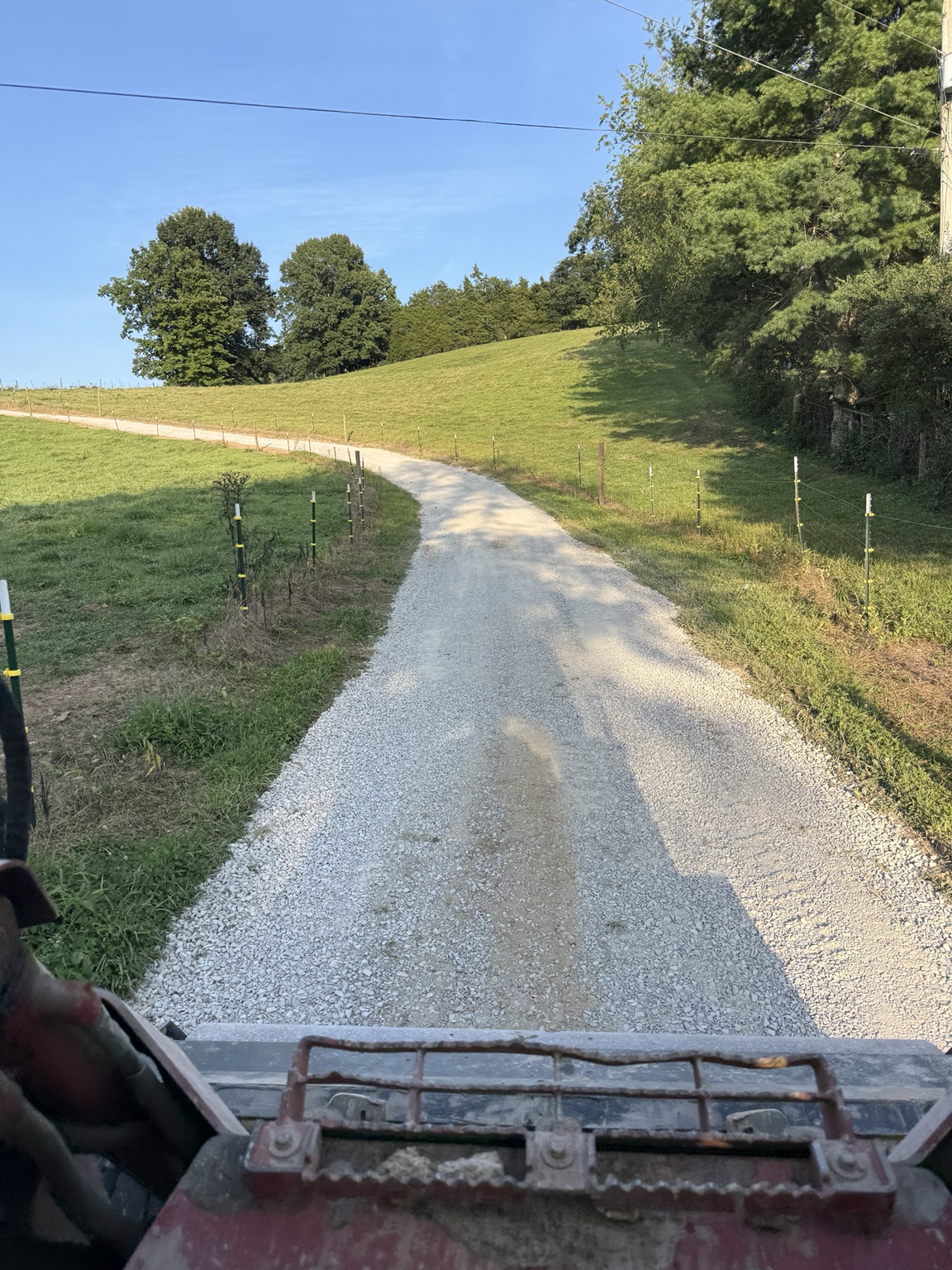 Fresh gravel driveway through rural property